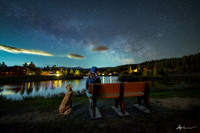a photo of a girl and her dog under the stars